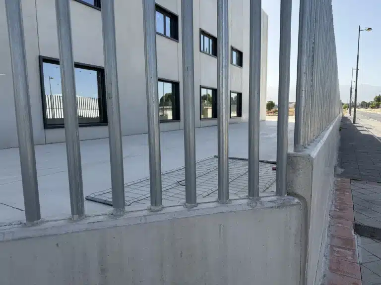 Celosía de lamas verticales de hormigón prefabricado en fachada de nave industrial — Los Cahices, Granada