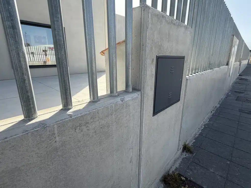 Celosía de lamas verticales de hormigón prefabricado en fachada de nave industrial — Los Cahices, Granada